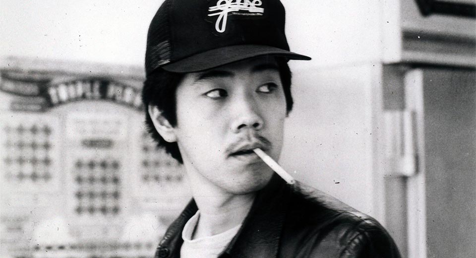 Chan with a cigarette in his mouth.