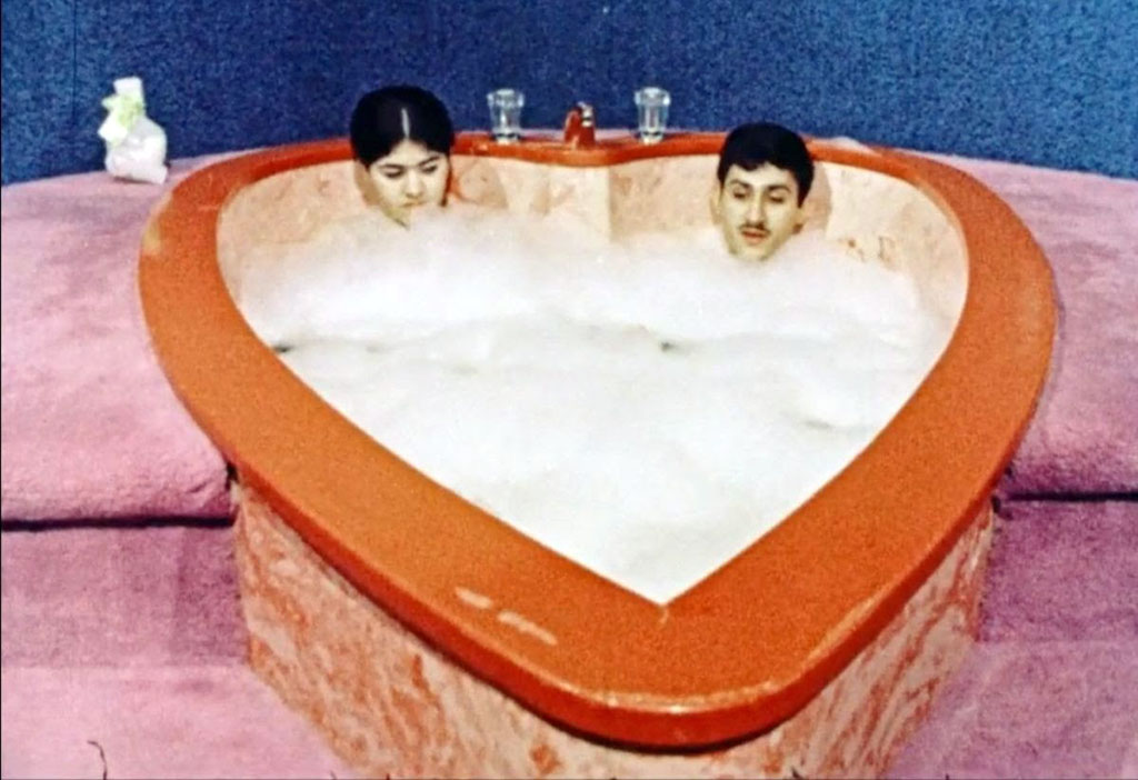 A couple enjoying a bubble bath.