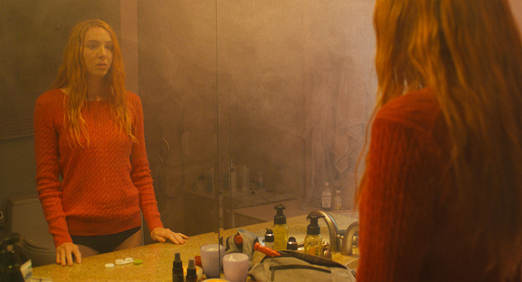 Woman standing in front of mirror.