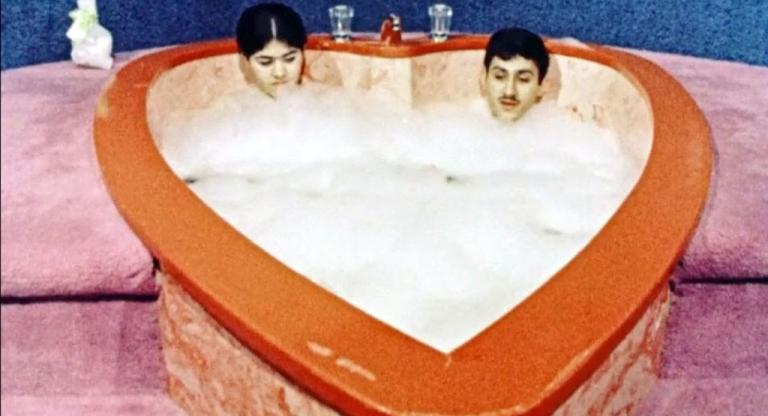 A couple enjoying a bubble bath.